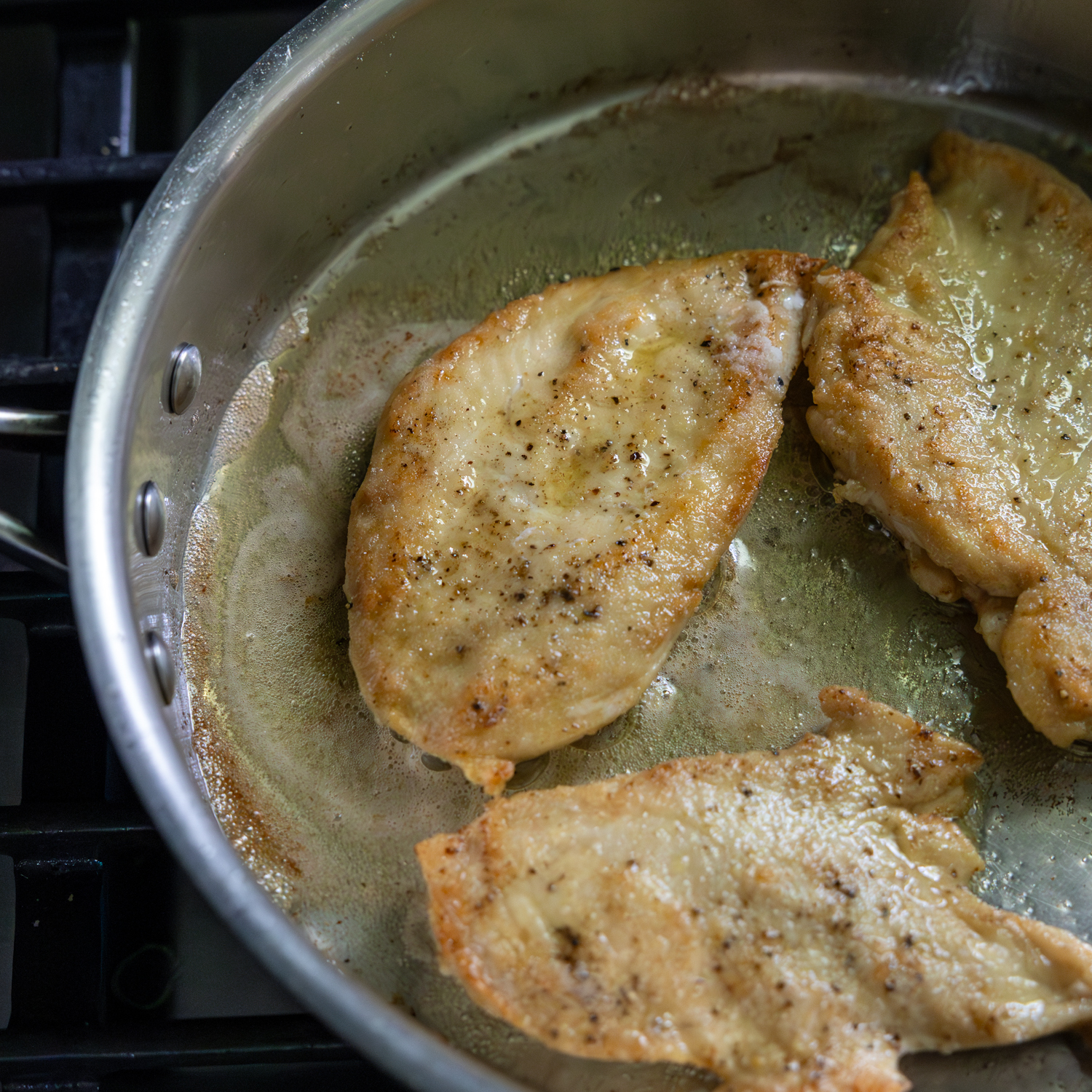 Chicken cutlets being fried.