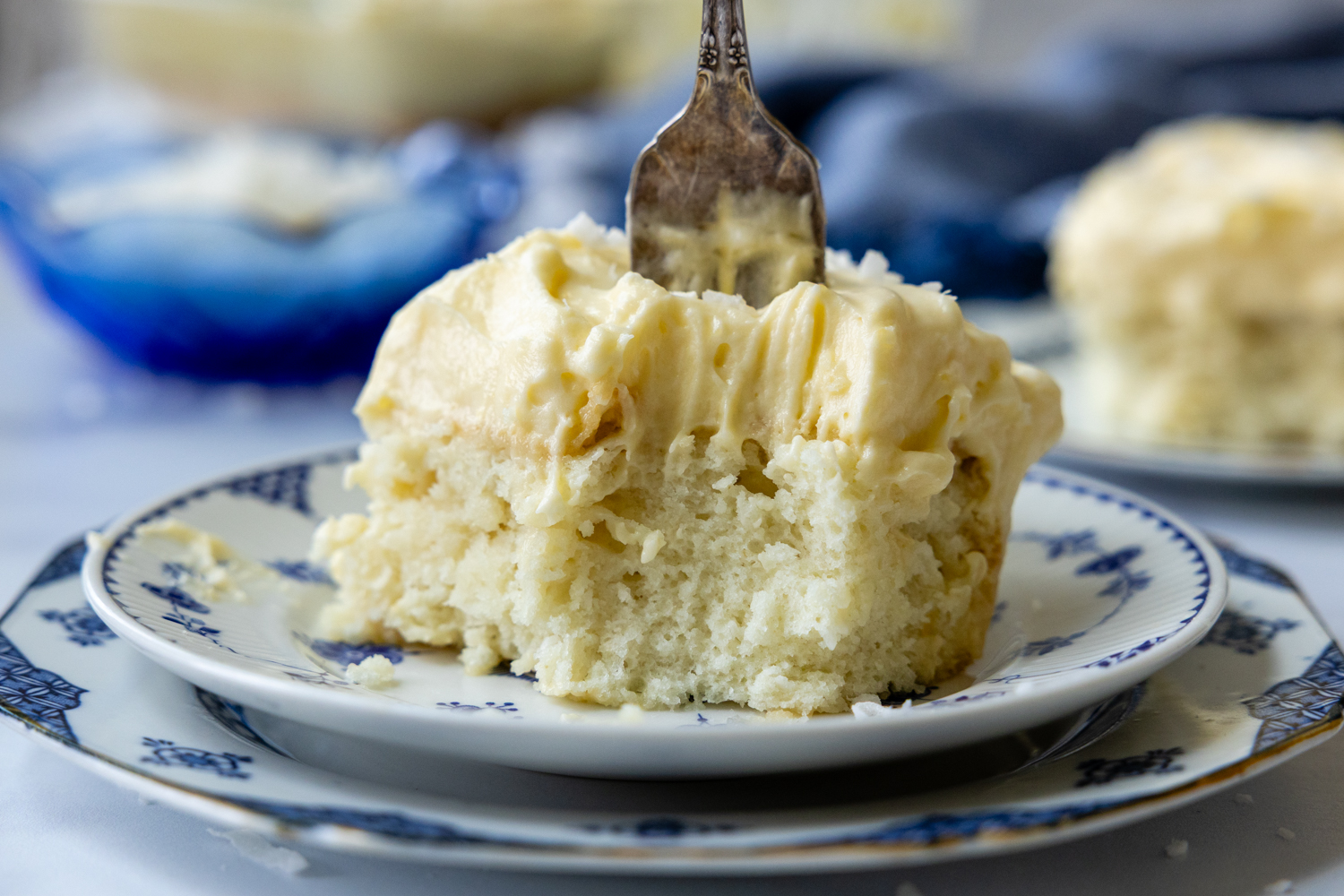 Cake on a plate with a fork sticking out the top.