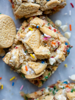 overhead shot of funfetti bars with crushed Oreos on top and a couple Golden Oreos laying next to it.