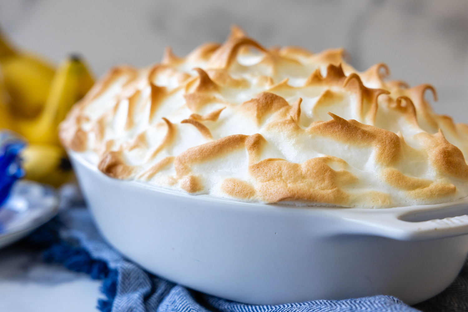 Cooked peaks of the banana pudding topping in a baking dish.