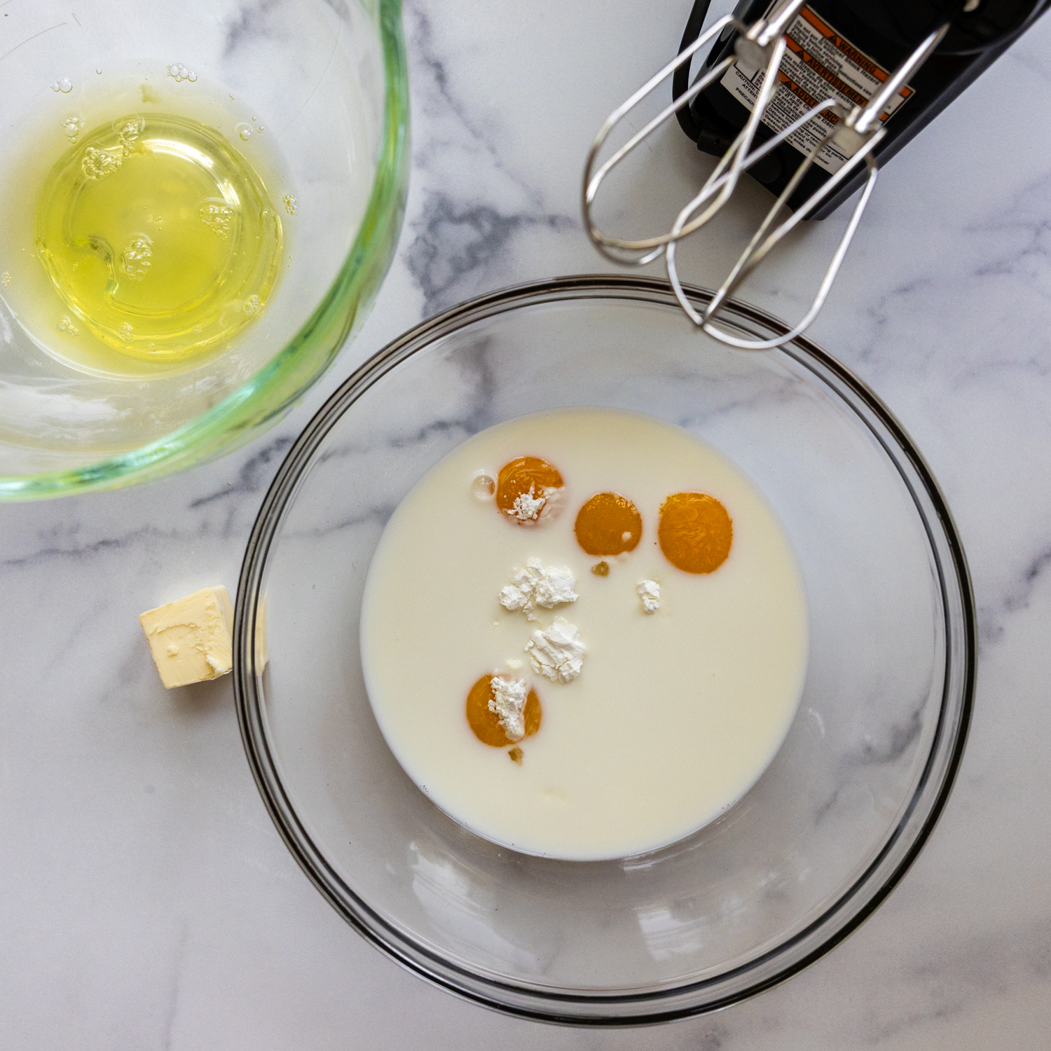 Eggs and cream of tartar in a mixing bowl.
