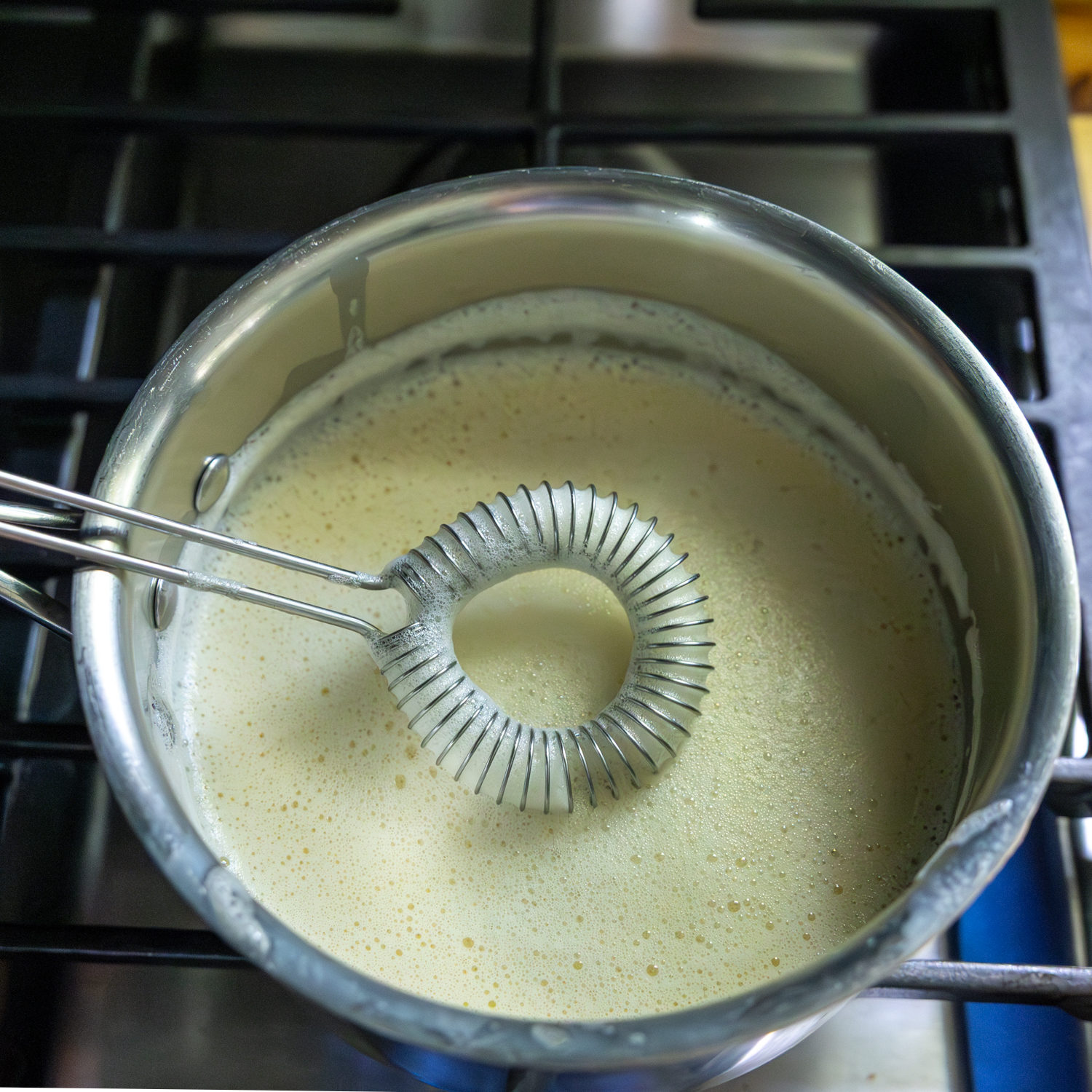 Mixture in sauce pan with whisk.