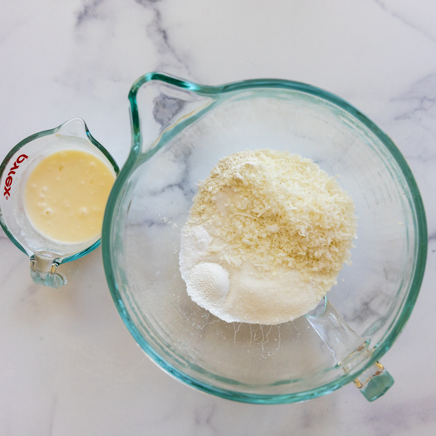 Cake ingredients in glass measuring cups.