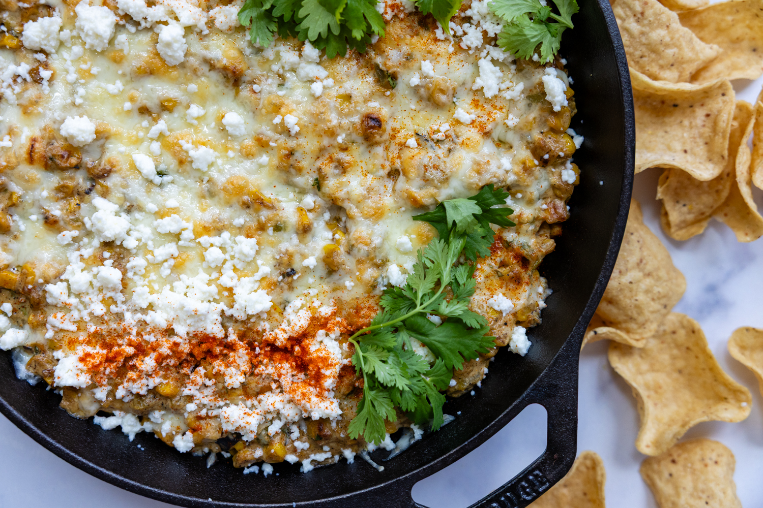 Dip in skillet garnished with parsley