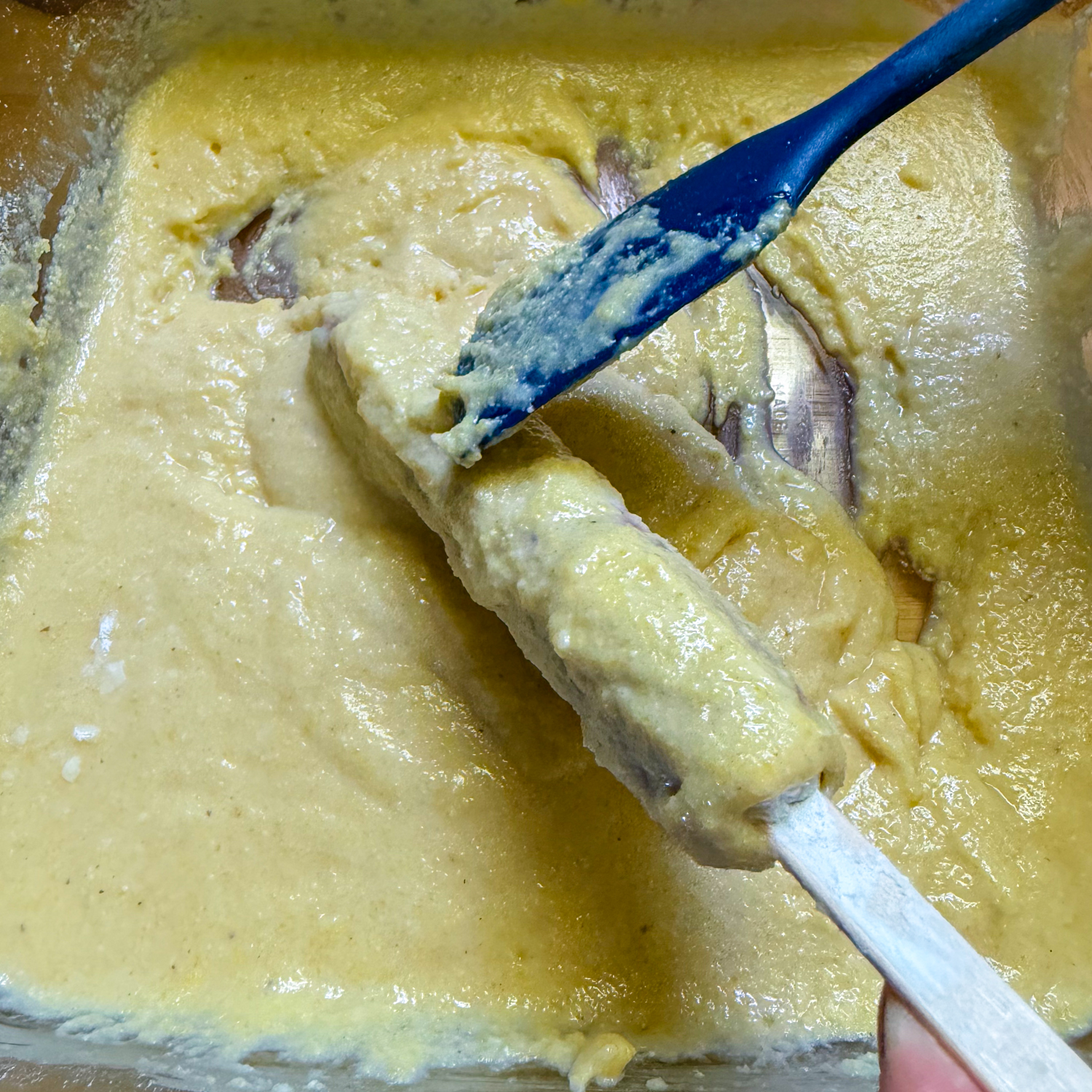 Prepared hot dog being battered.