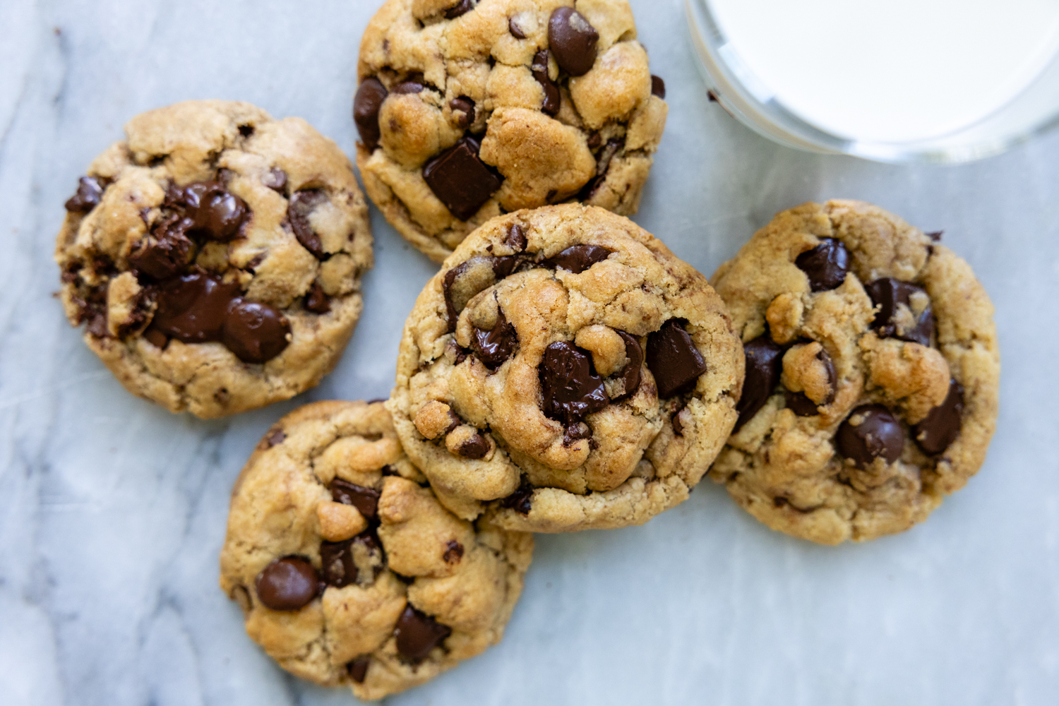 Overheads shot of cookies next to a glass of milk.