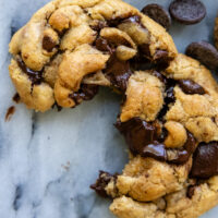 Brown butter chocolate chip cookie cracked open showing the chewy goodness,