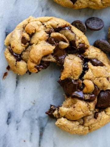Brown butter chocolate chip cookie cracked open showing the chewy goodness,