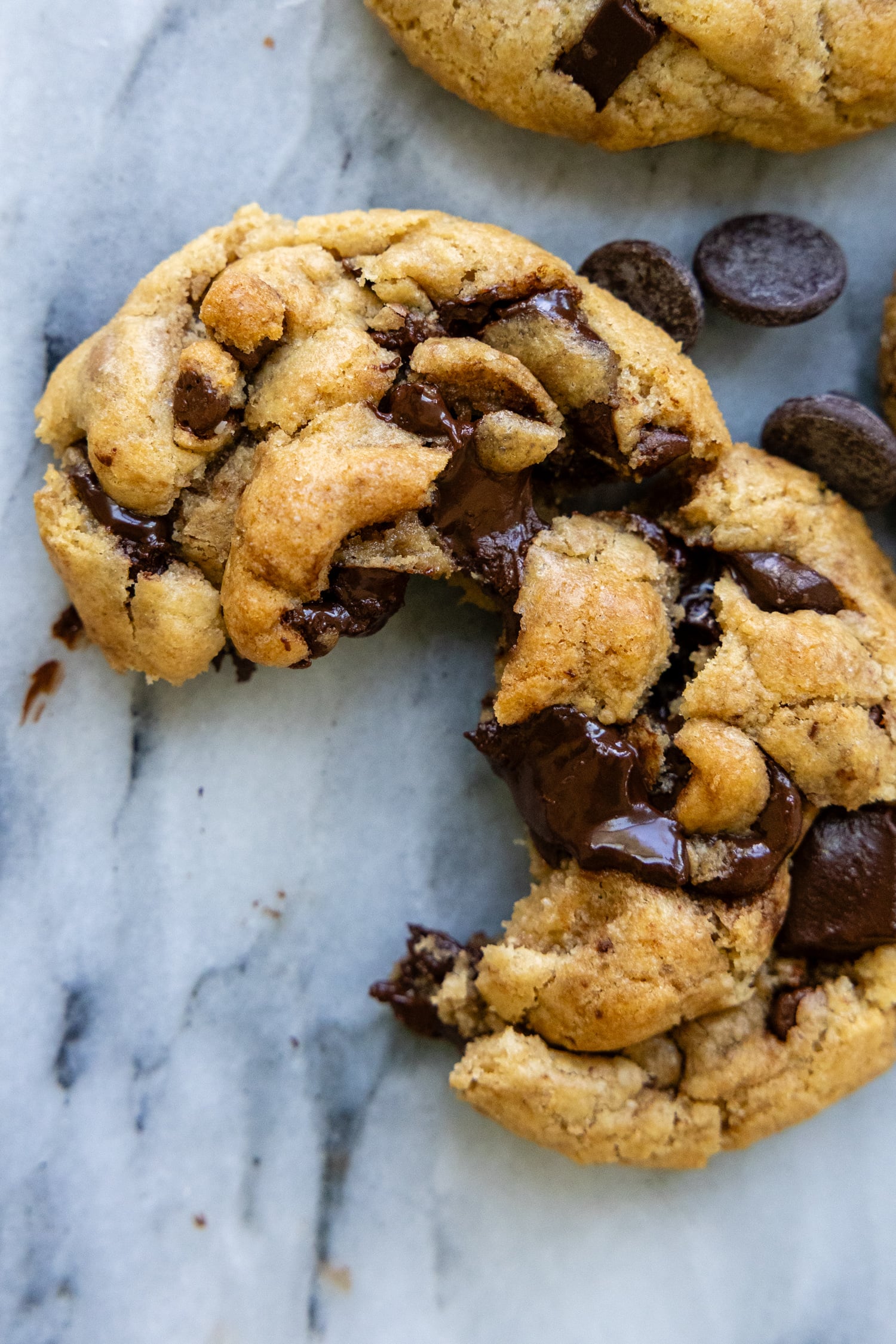 Brown butter chocolate chip cookie cracked open showing the chewy goodness,