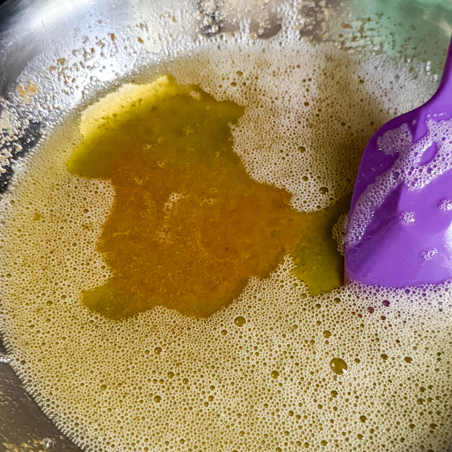 Melted butter in a glass bowl.
